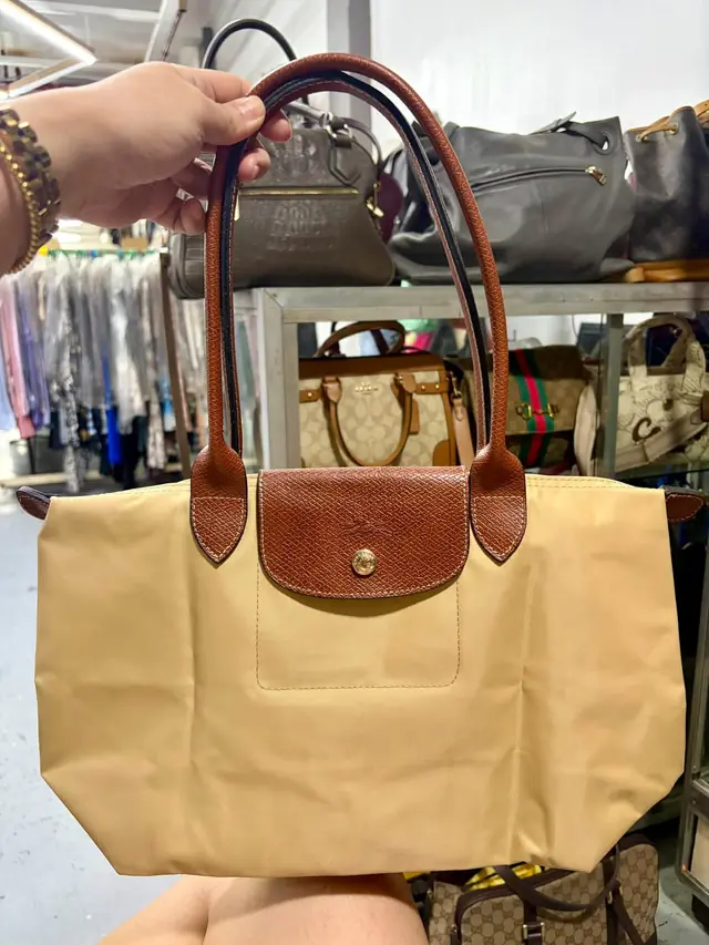 Beige nylon tote with tan leather flap and long shoulder straps